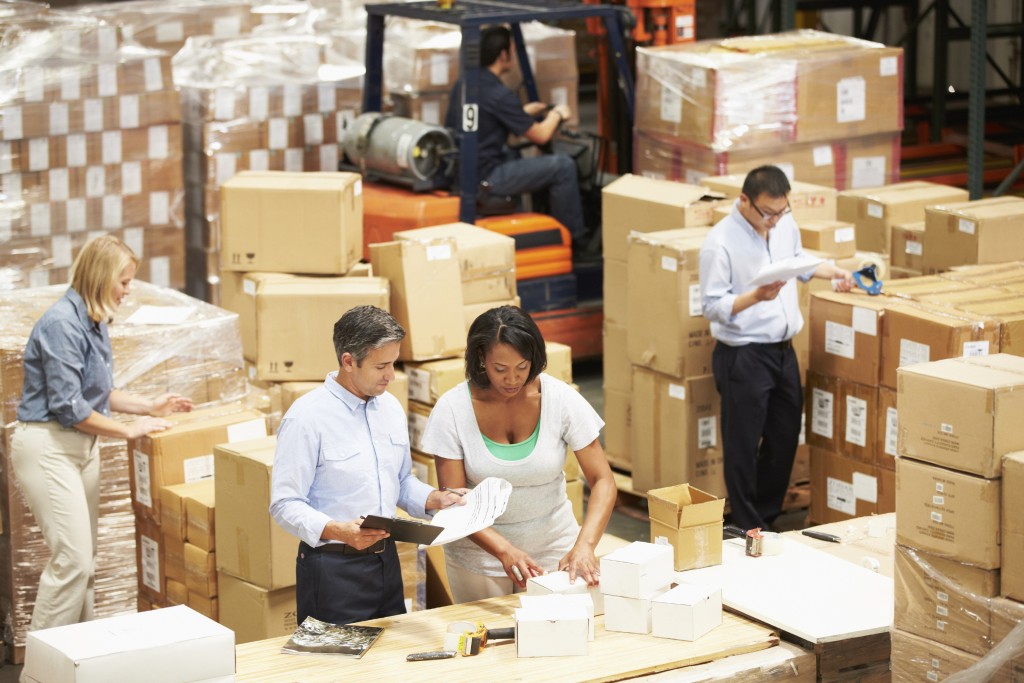 Workers In Warehouse Preparing Goods For Dispatch